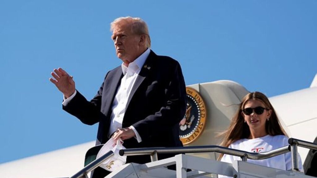 President Donald Trump waves as he arrives with his granddaughter kai Trump on Air Force One at Republic Airport, Friday, Sept. 26, 2025, in Farmingdale, N.Y. (AP Photo/Alex Brandon)