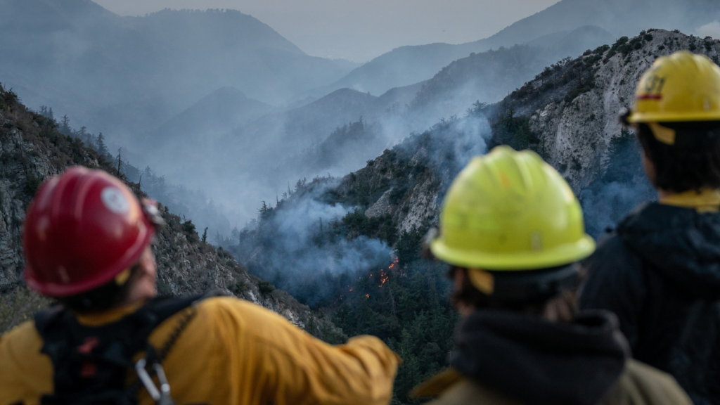 Firefighters near the Eaton fire in the mountains between Altadena and Mount Wilson in Los Angeles County, Jan. 10, 2025. Pollution from fires, intensified by rising temperatures, is on track to become one of America’s deadliest climate disasters. (Loren Elliott/The New York Times)