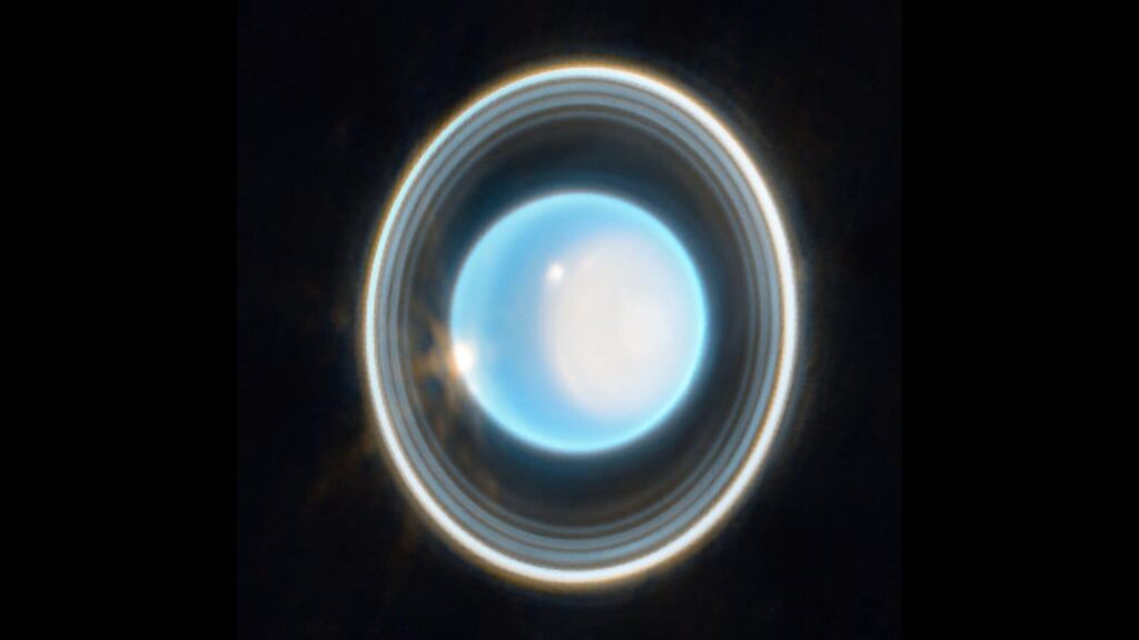 Uranus’s rings may hide unseen moons, a new study suggests | Technology News New research highlights stark differences between Uranus's μ- and ν-rings. The μ-ring appears blue, suggesting it is made up of extremely fine icy particles, likely sourced from Mab, one of the planet’s inner moons(Image: ESA)