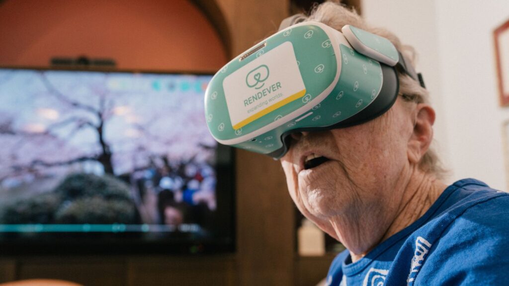 Pat Bridges watches a Japanese cherry blossom video with a VR headset in the multi purpose library at Castle Argyle in Los Angeles, Feb. 2, 2026.