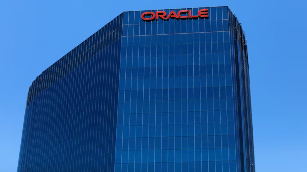 Oracle set to cut thousands of jobs amid rising AI investments and cost pressures | Technology News The Oracle logo is shown on an office.